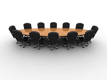 A conference table with 12 black chairs